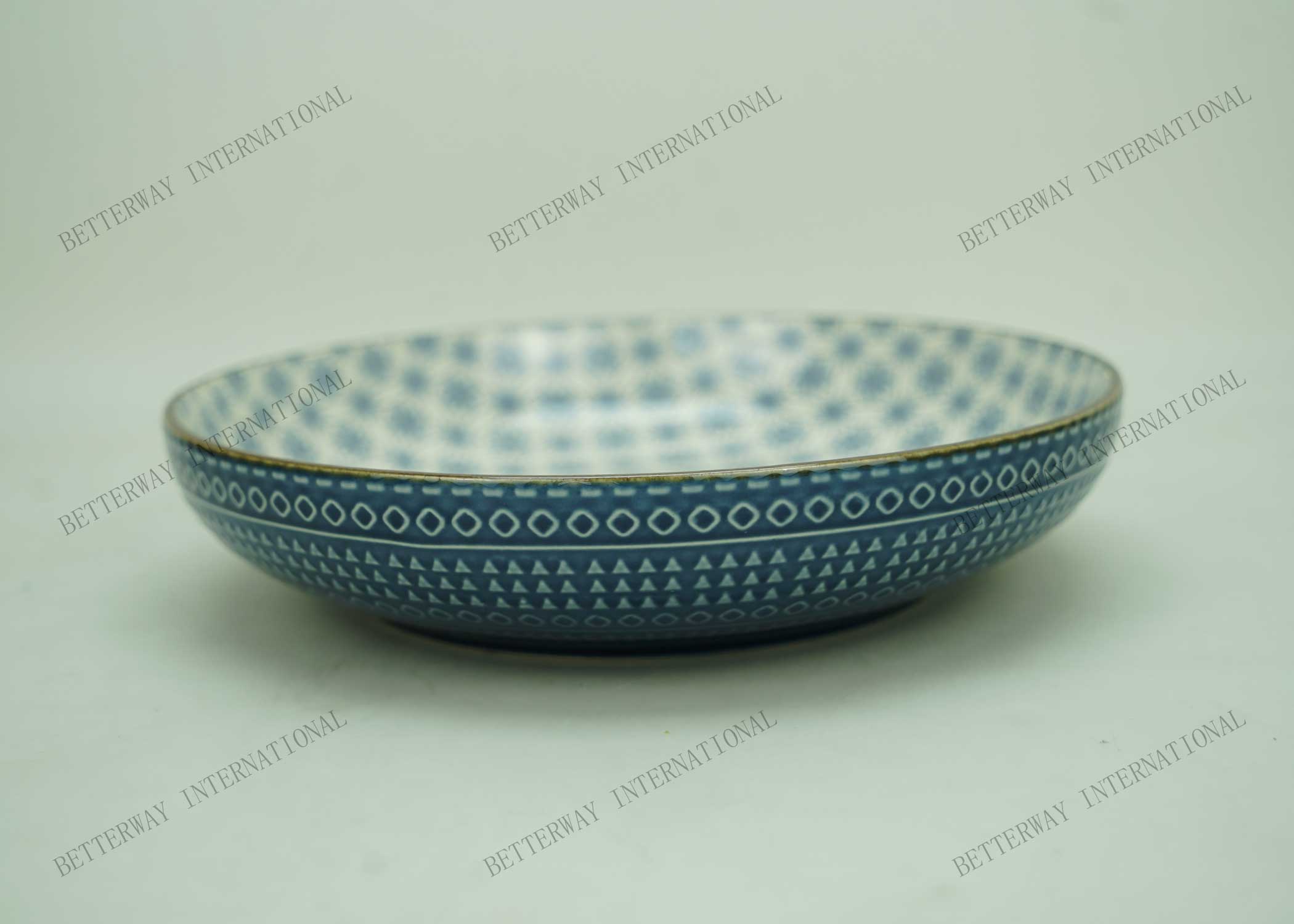 Stoneware embossed soup bowl with full inglazed pattern inside